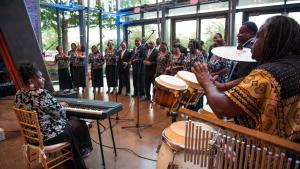 A group of musicians with a choir perform in the Main Lobby at the South Carolina State Museum.