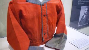 Red shirt with blue collar and cuff on exhibition in display case