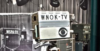 Vintage television camera with WNOK-TV written on the side with the CBS 'eye' logo 