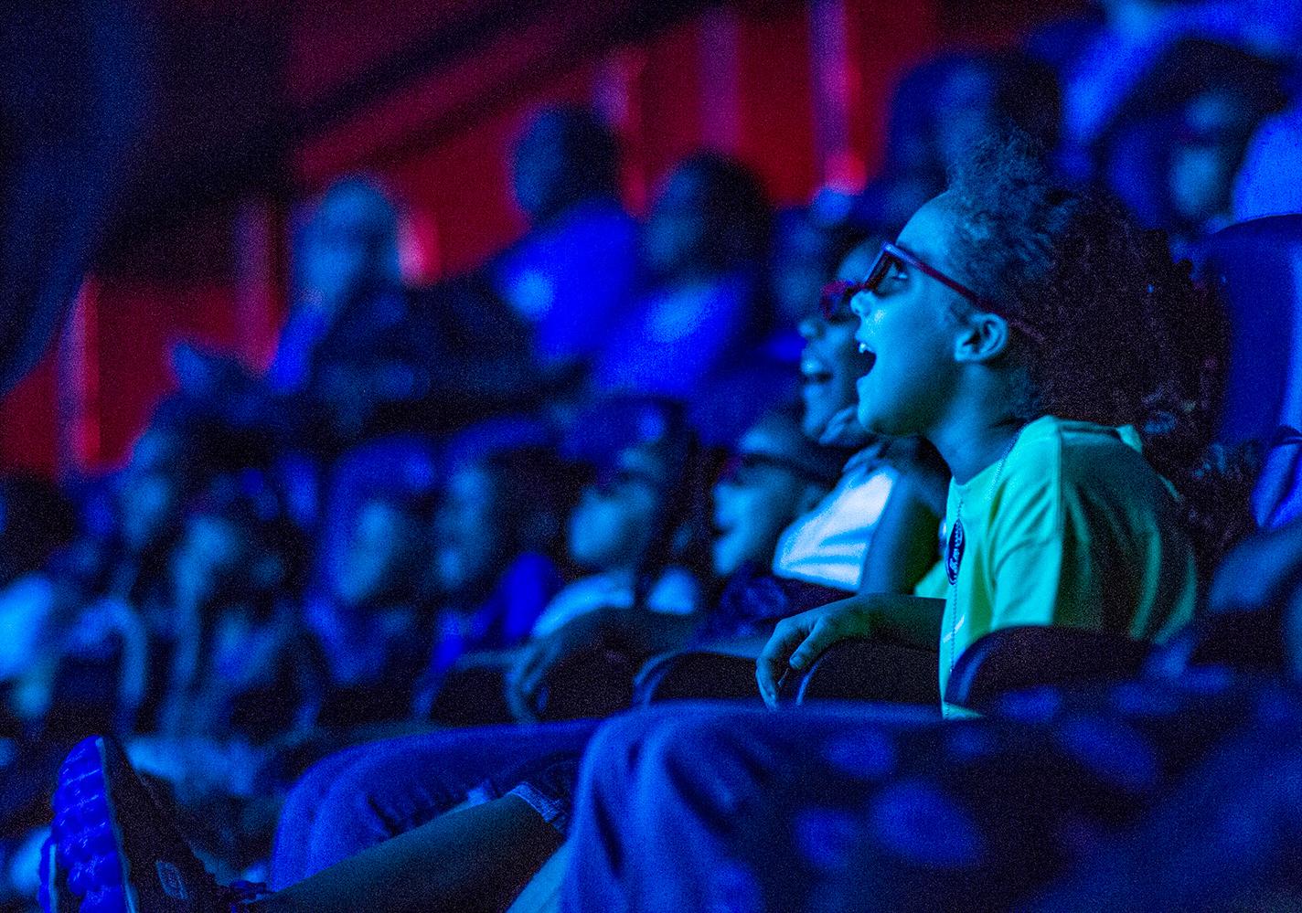 Young girl gasps in delight as she experiences a show in the in the 4D theater audience at the State Museum.