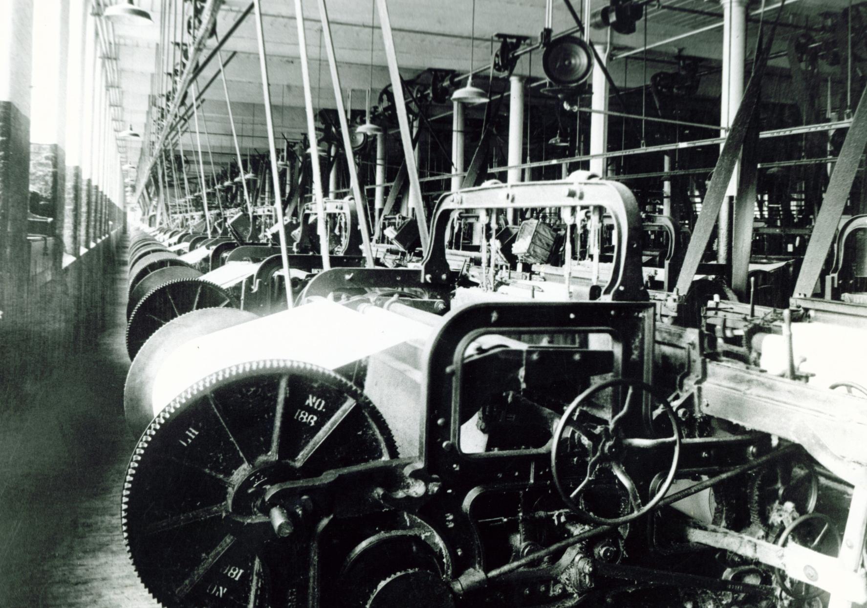 Black and white image of Columbia Mills interior showing loom machinery