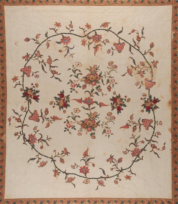 Quilt with floral chintz border and central motif of vines and flowers